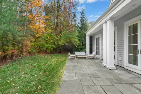 a view of a house with backyard and sitting area