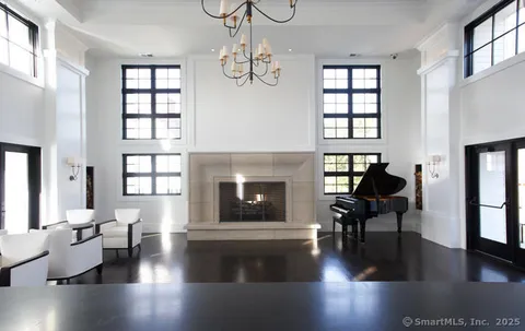 a living room with fireplace furniture and a wooden floor