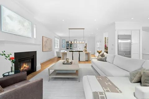 a living room with furniture a fireplace and a table