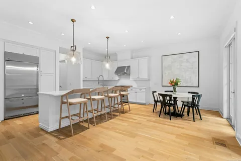 a large kitchen with a table and chairs