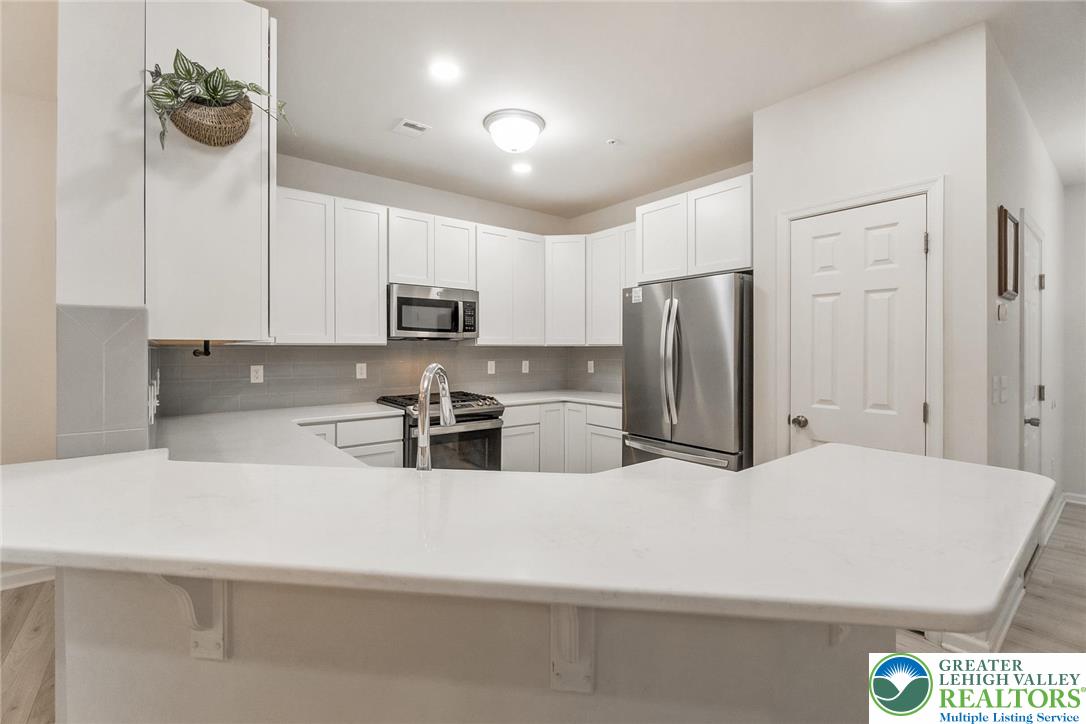164 Maureen Lane Allentown, PA 18104 - Photo 11 of 28 a kitchen with stainless steel appliances a refrigerator sink and cabinets