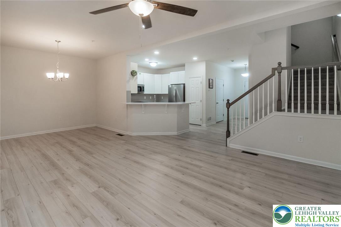 164 Maureen Lane Allentown, PA 18104 - Photo 7 of 28 a view of a hallway with wooden floor and chandelier