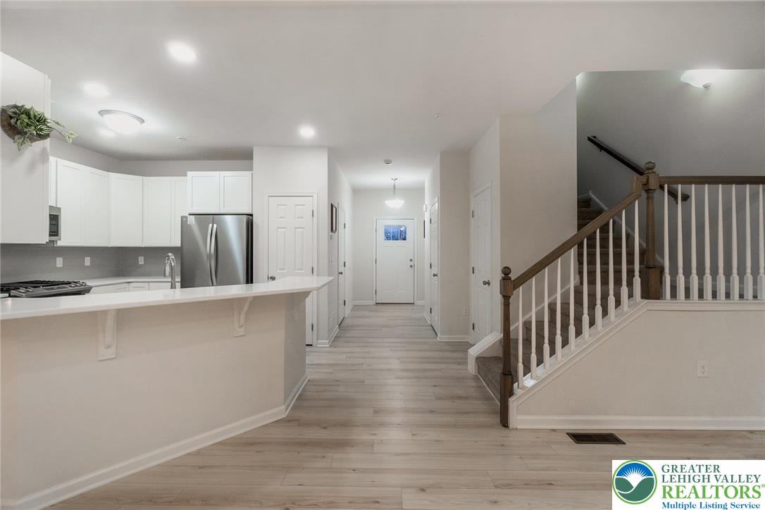 164 Maureen Lane Allentown, PA 18104 - Photo 9 of 28 a view of kitchen with center island wooden floor and stainless steel appliances