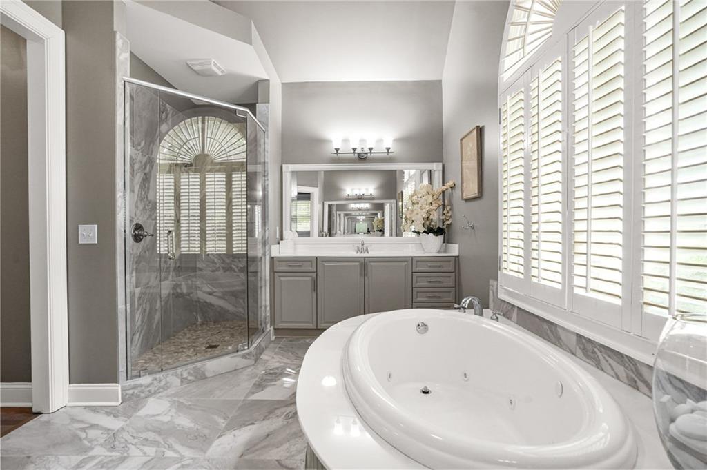 509 Crested Hawk Ridge Canton, GA 30114 - Photo 32 of 89 a bathroom with a bathtub and a shower