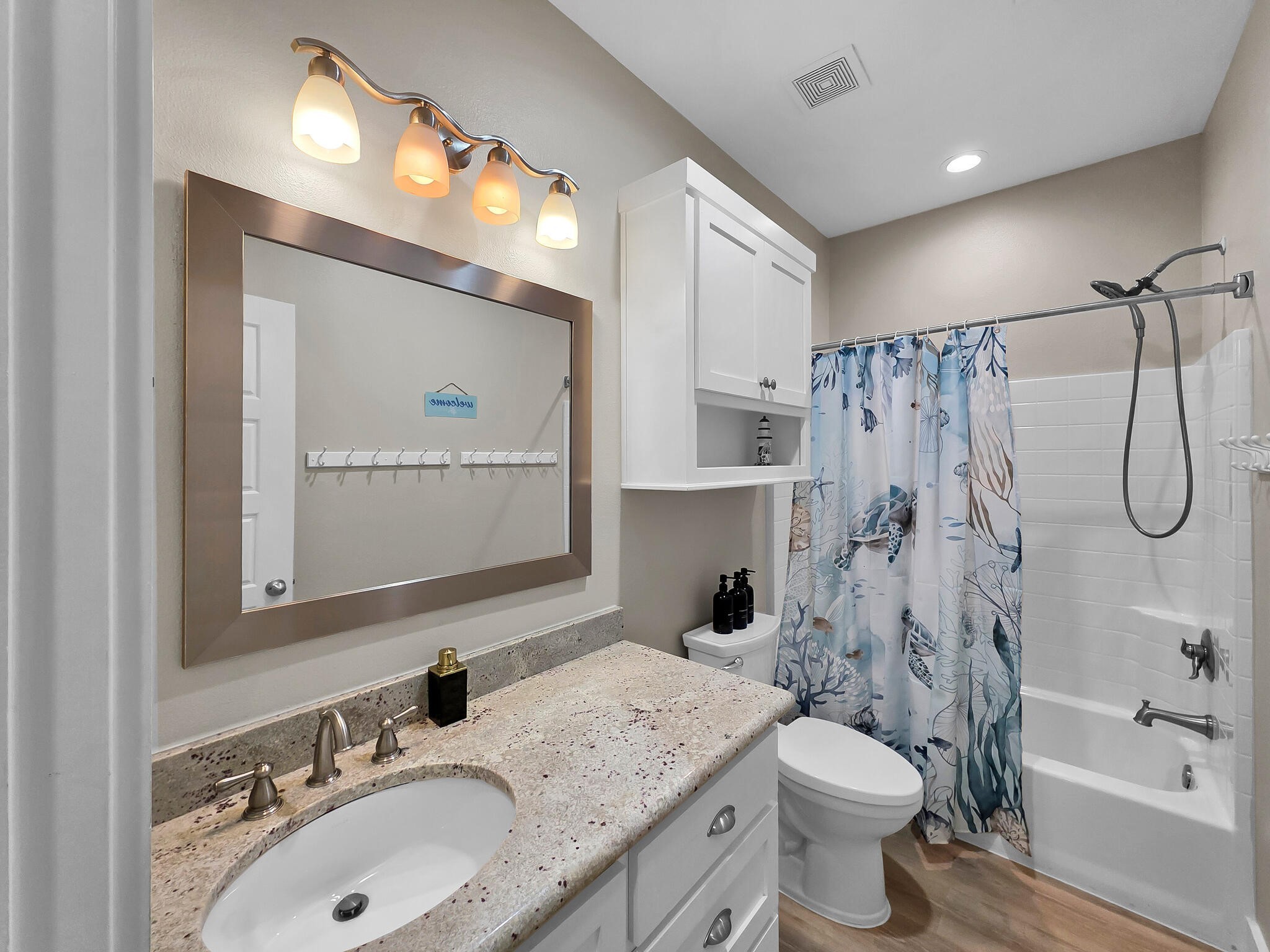 1215 Gulf Road Crystal Beach, TX 77650 - Photo 17 of 34 a bathroom with a sink vanity toilet and shower