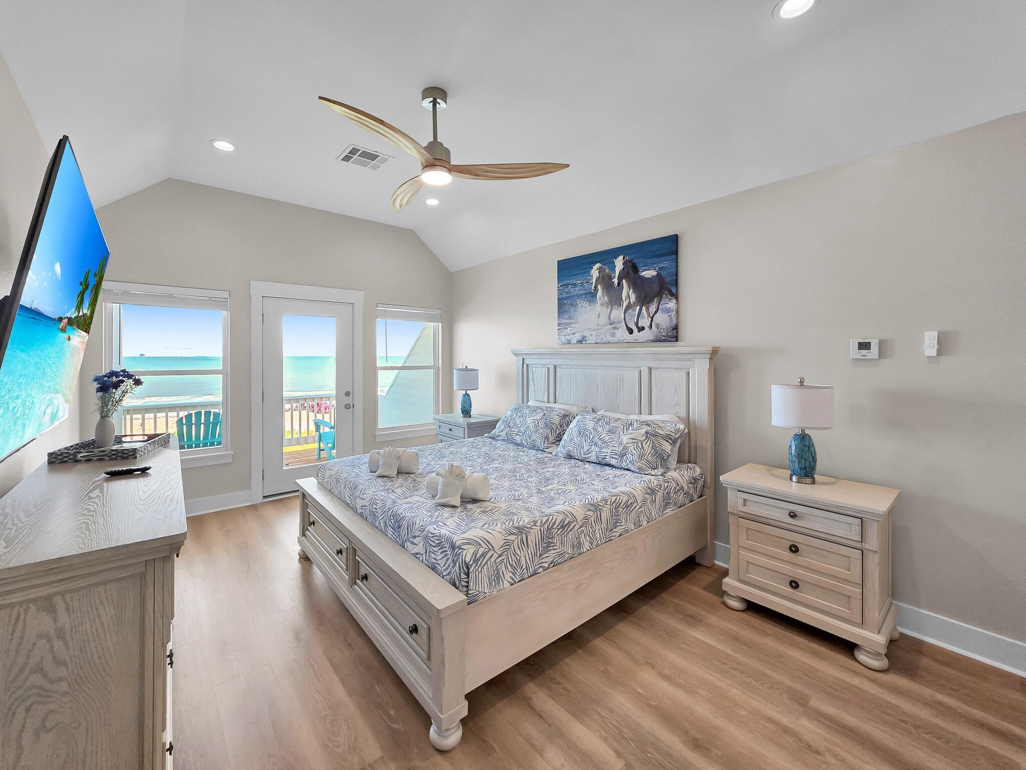 1215 Gulf Road Crystal Beach, TX 77650 - Photo 23 of 34 a bedroom with a bed and a flat screen tv