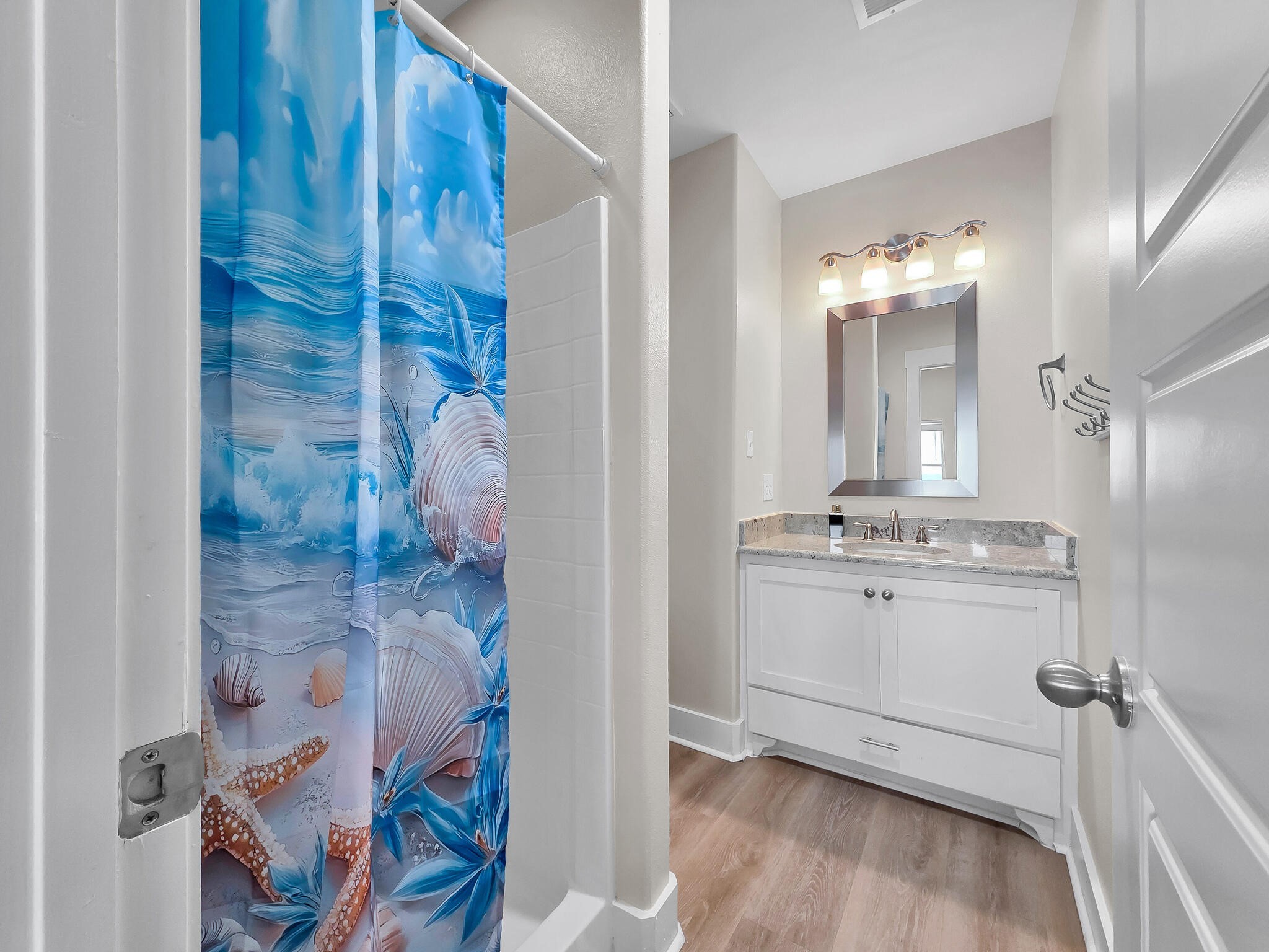 1215 Gulf Road Crystal Beach, TX 77650 - Photo 24 of 34 a bathroom with a sink and a mirror