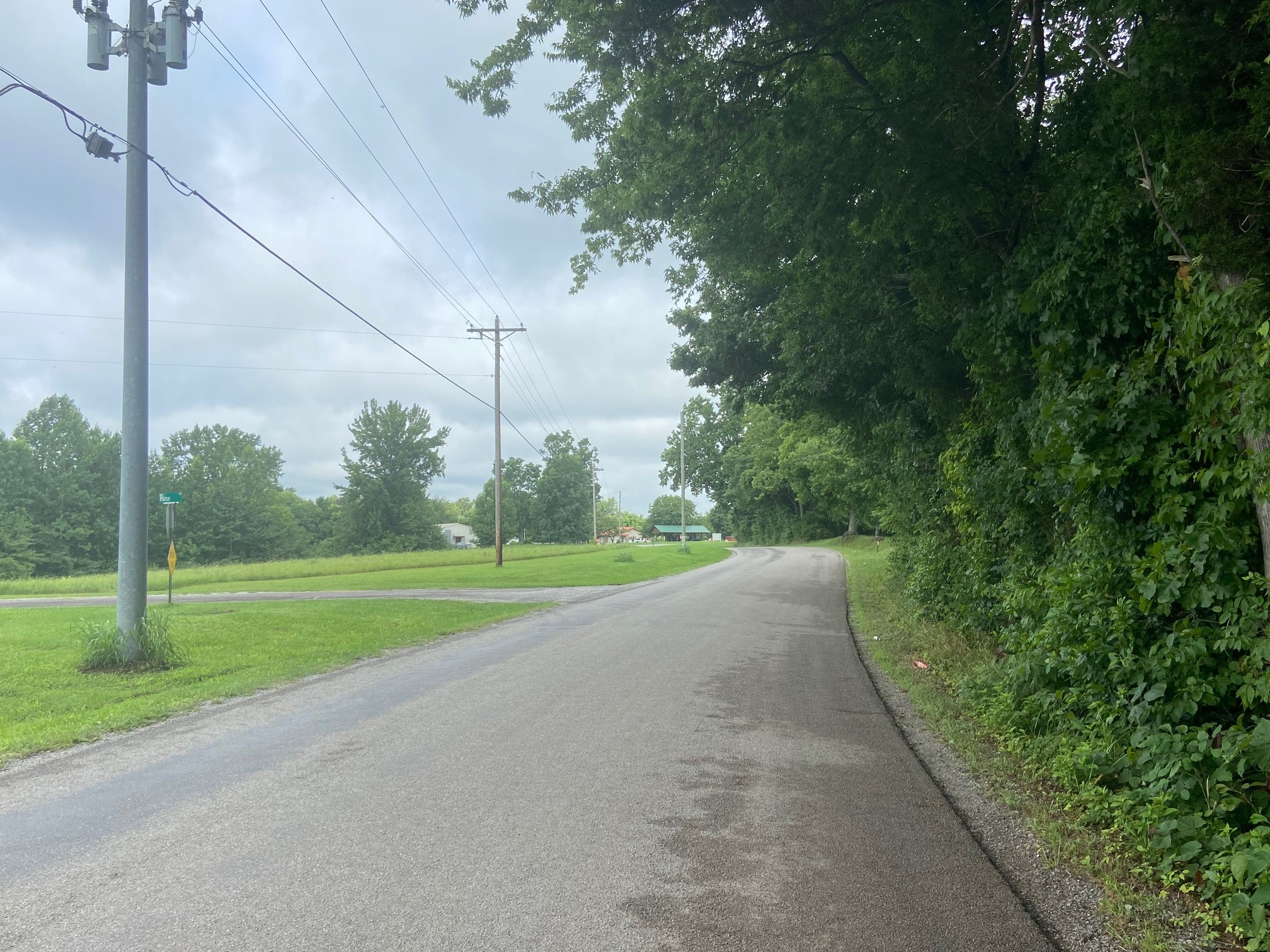a view of a road with a big yard