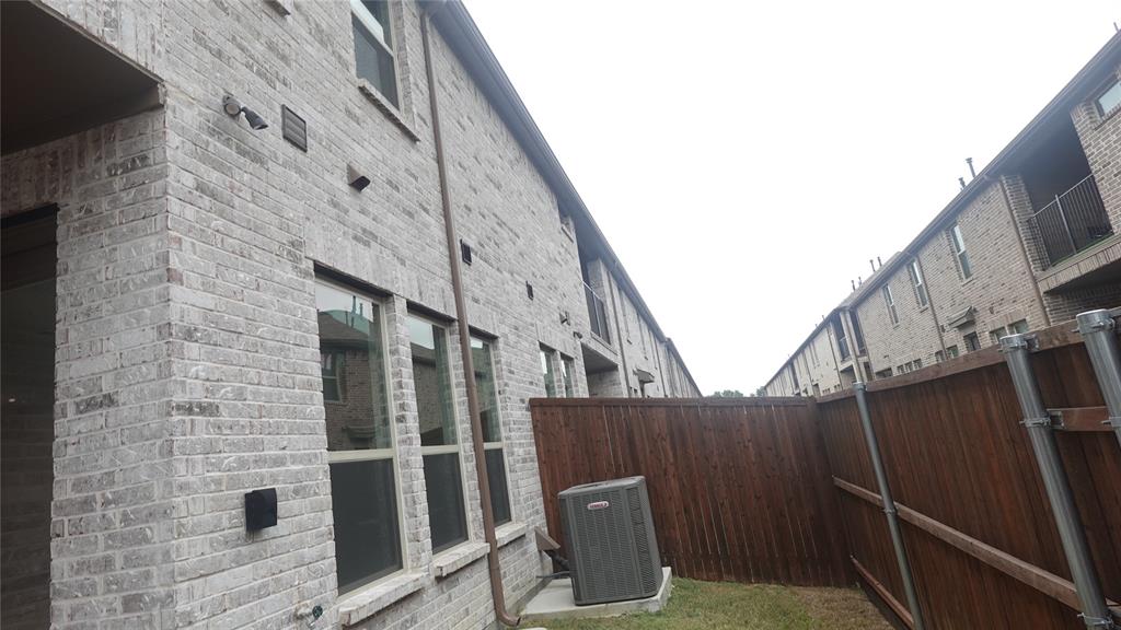 824 Heart Reef Road Plano, TX 75075 - Photo 18 of 19 Brick exterior with multiple windows and a wood fence
