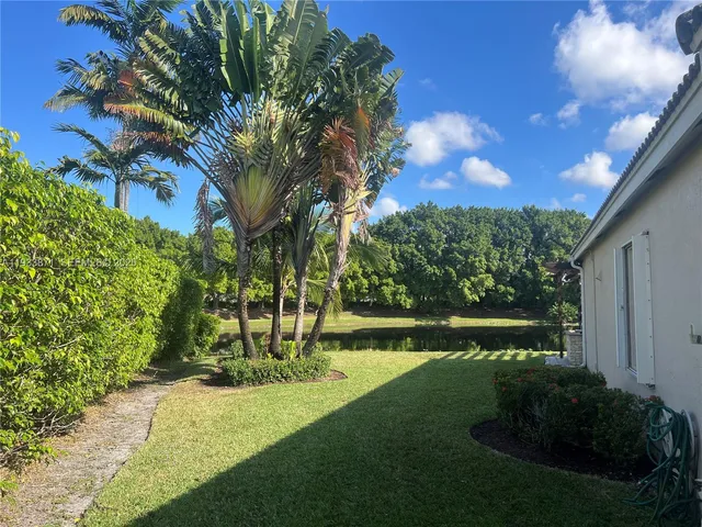 a view of a garden with a building in the background