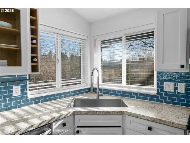a kitchen with granite countertop a sink and a counter top space