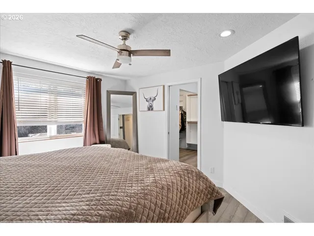 a bedroom with a bed and a flat screen tv