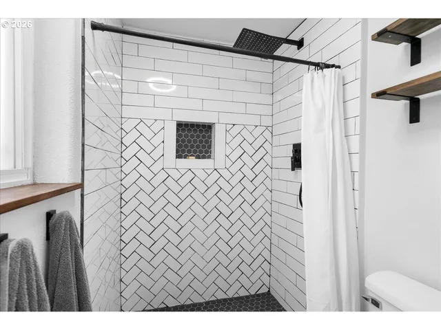 a bathroom with a shower and a sink