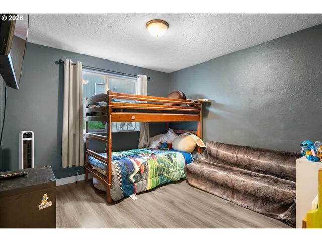 a bedroom with a bed and window