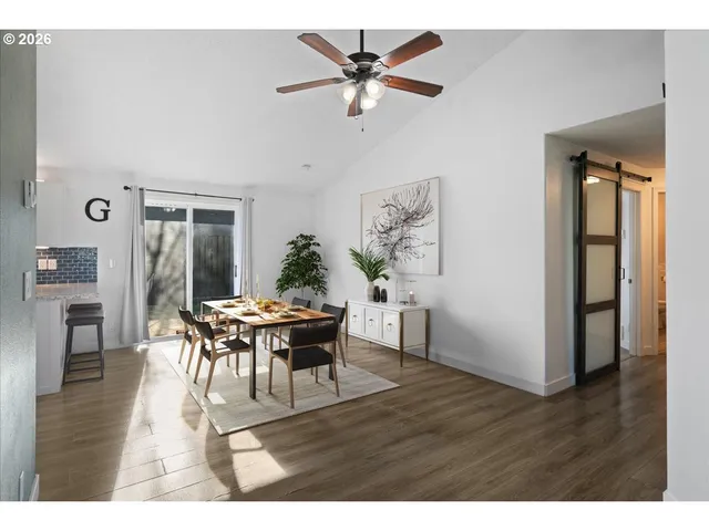 a view of a dining room with furniture and wooden floor