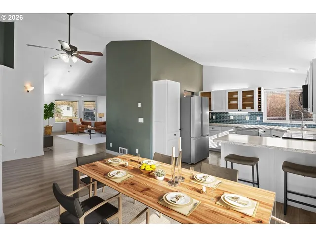 a kitchen with stainless steel appliances kitchen island granite countertop a refrigerator and a stove