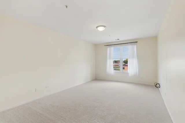 a view of a room with window and a wooden floor