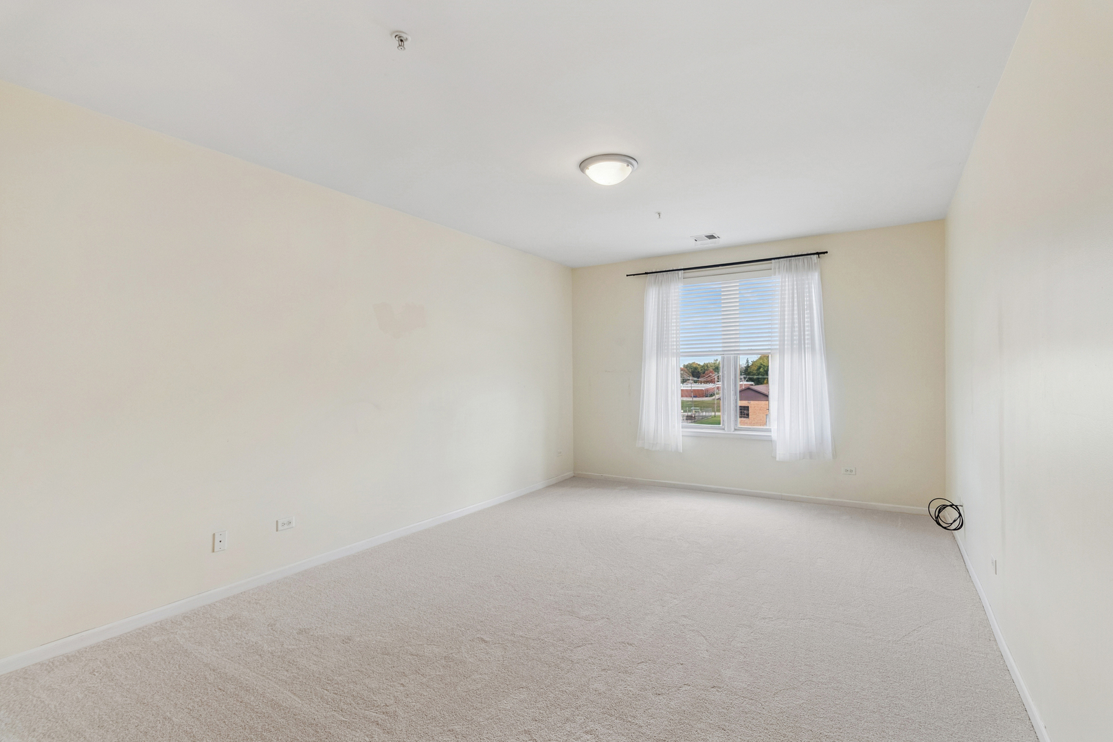 271 East Railroad Avenue, Unit 302 Bartlett, IL 60103 - Photo 14 of 21 a view of a room with window and a wooden floor