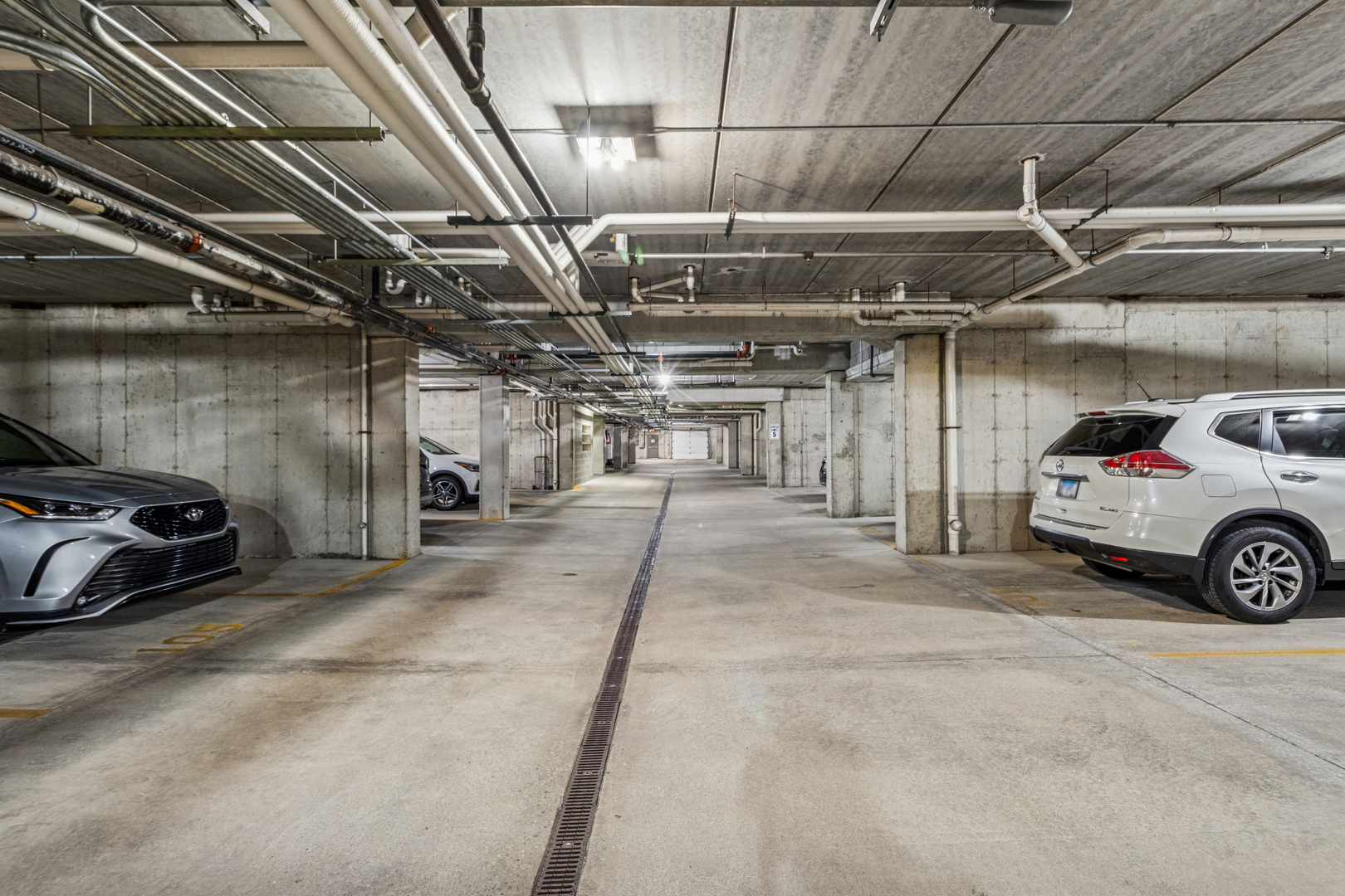 271 East Railroad Avenue, Unit 302 Bartlett, IL 60103 - Photo 19 of 21 a view of parking garage with cars