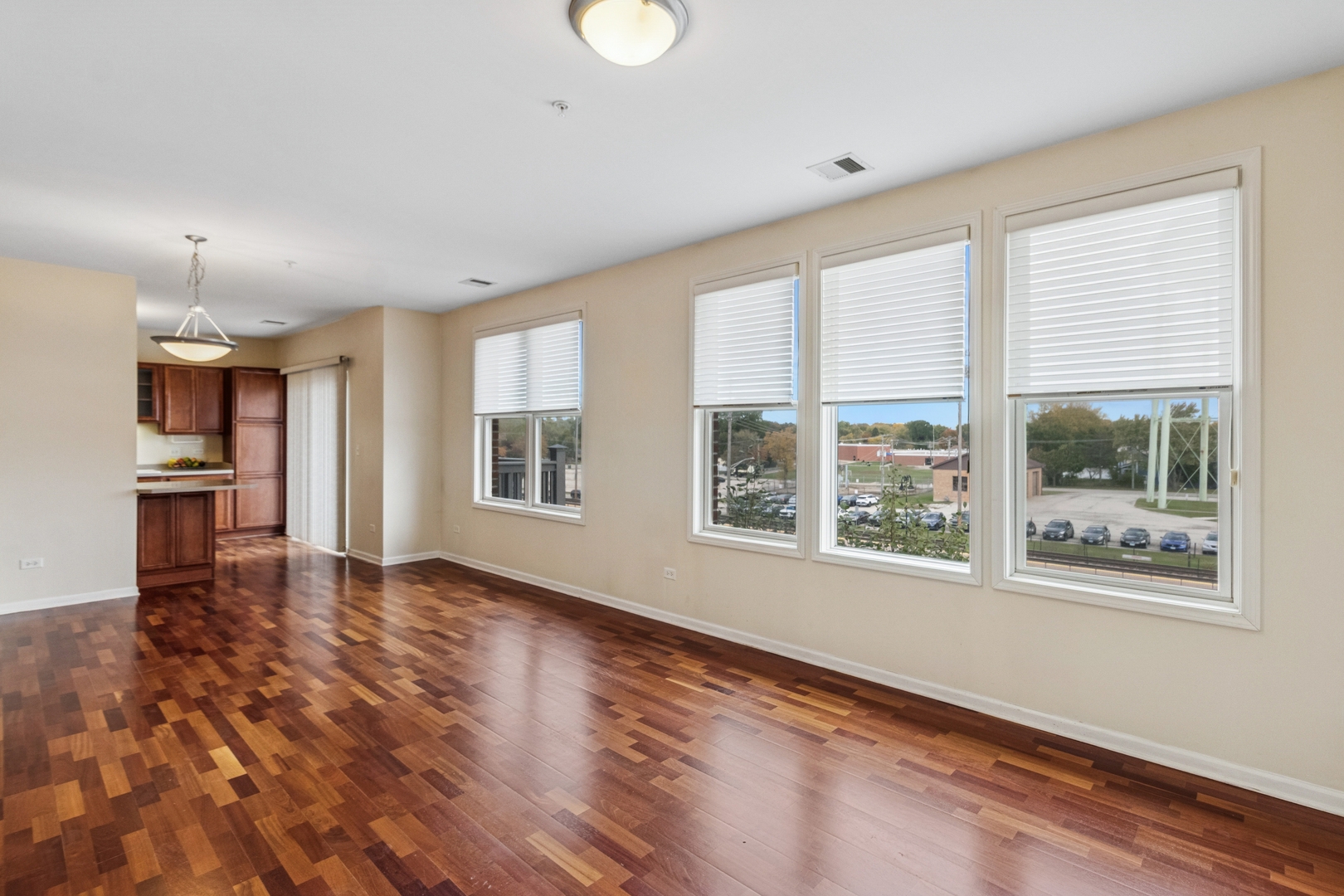 271 East Railroad Avenue, Unit 302 Bartlett, IL 60103 - Photo 5 of 21 a view of an empty room with a window and wooden floor