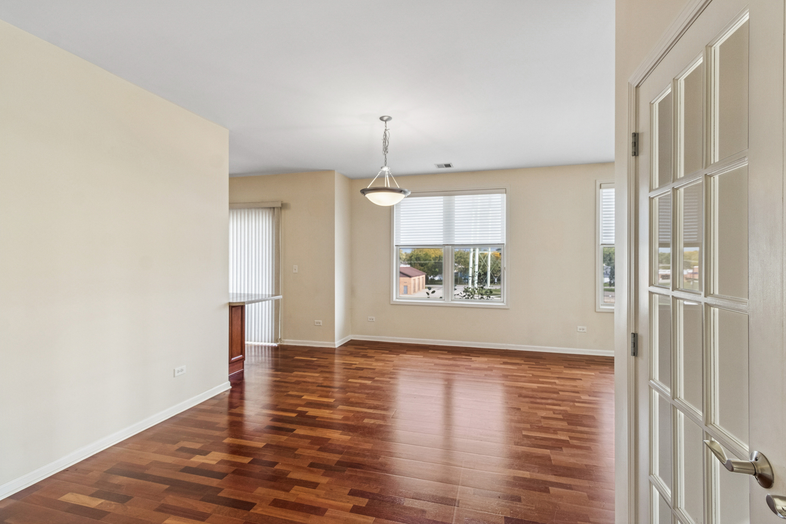 271 East Railroad Avenue, Unit 302 Bartlett, IL 60103 - Photo 6 of 21 a view of an empty room with window and wooden floor