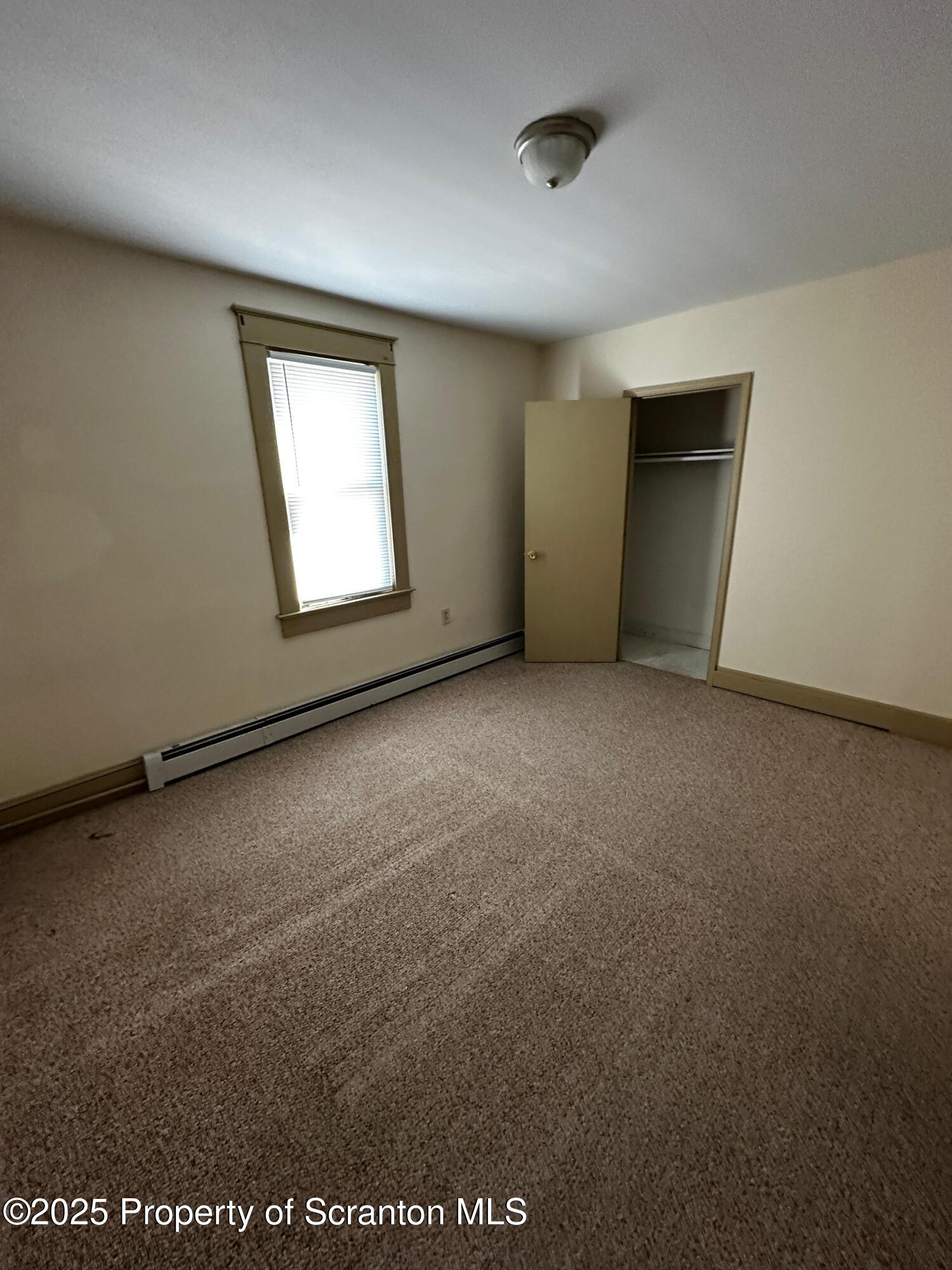 an empty room with a empty space and windows