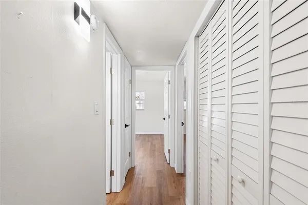 a view of a hallway with wooden floor