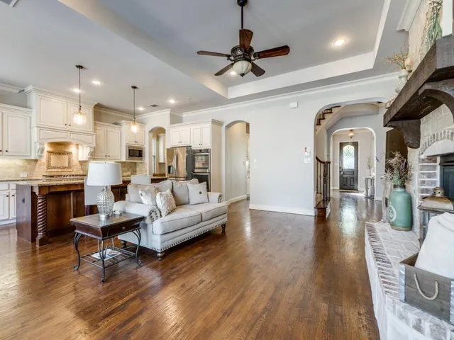 a living room with kitchen island furniture and a wooden floor