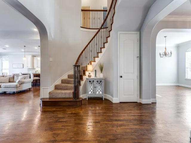 a view of entryway and hall with wooden floor