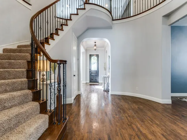 a view of entryway and hall with wooden floor