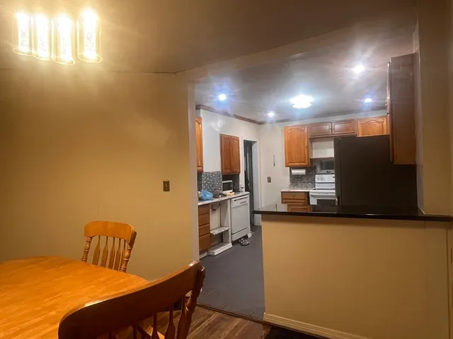 a view of a kitchen with kitchen island and a wooden floor