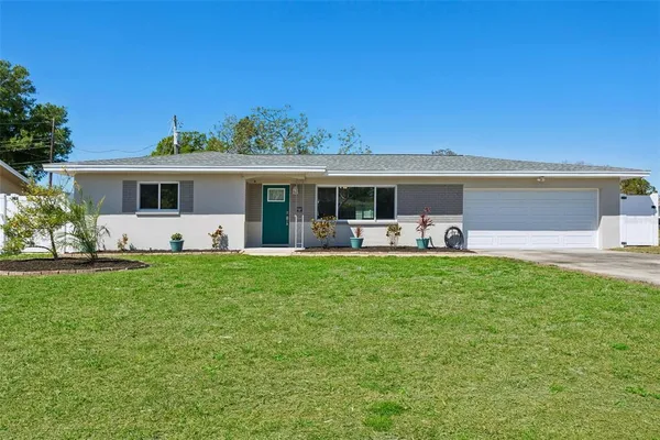 a front view of house with yard and outdoor seating