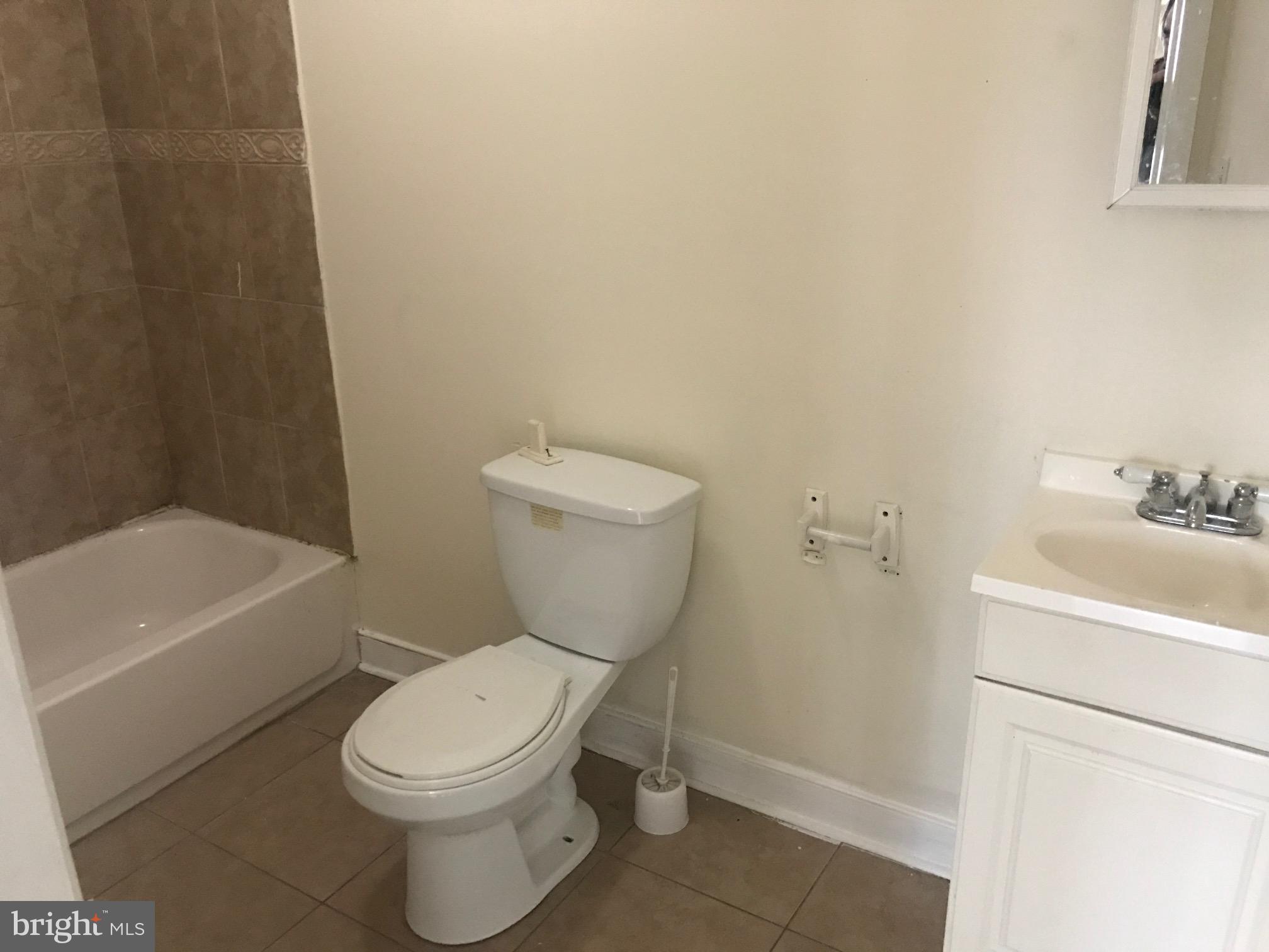 3427 North 2nd Street, Unit 2R Philadelphia, PA 19140 - Photo 5 of 5 a white toilet sitting next to a bath tub