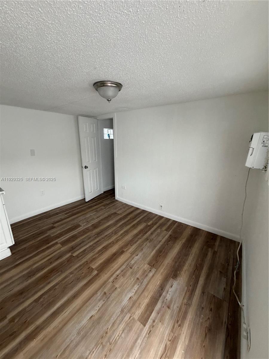 2980 Northwest 79th Street, Unit B Miami, FL 33147 - Photo 2 of 5 a view of empty room with wooden floor