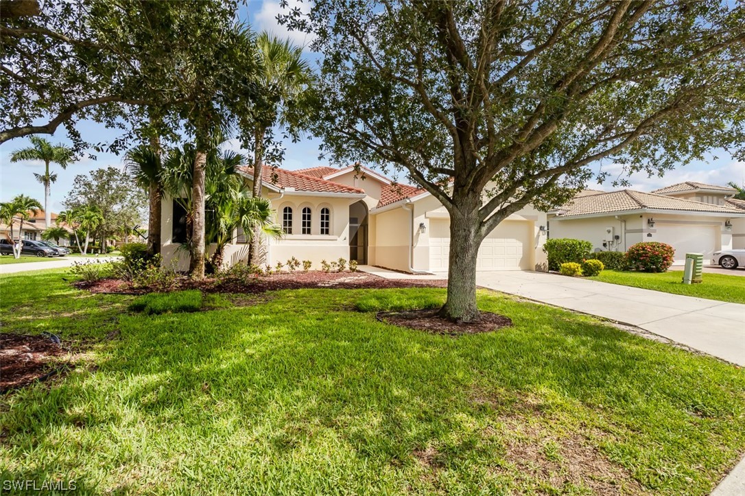 12893 Timber Ridge Drive Fort Myers, FL 33913 - Photo 1 of 30 a front view of a house with a yard