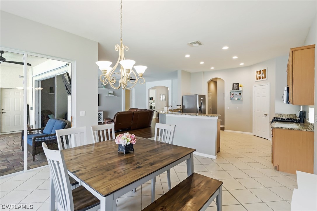 12893 Timber Ridge Drive Fort Myers, FL 33913 - Photo 13 of 30 a view of a dining room and a kitchen with a table chairs
