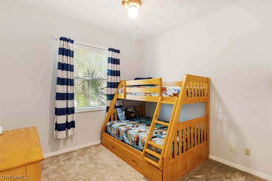 12893 Timber Ridge Drive Fort Myers, FL 33913 - Photo 20 of 30 a bedroom with a bed and a window
