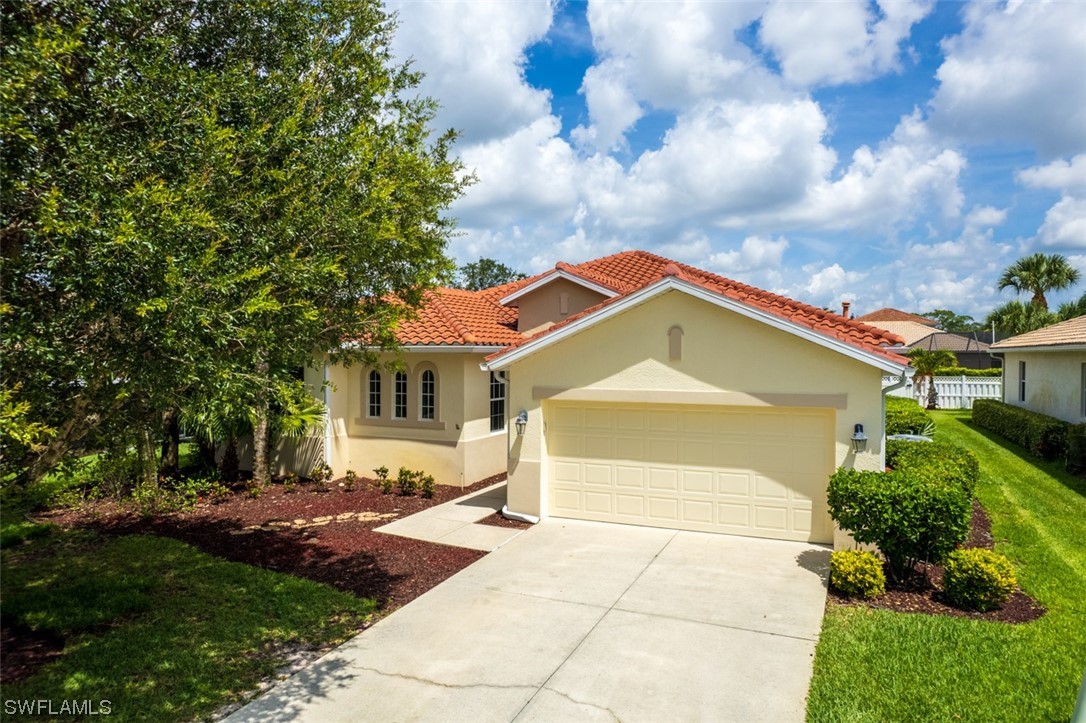 12893 Timber Ridge Drive Fort Myers, FL 33913 - Photo 2 of 30 a front view of a house with a yard and garage