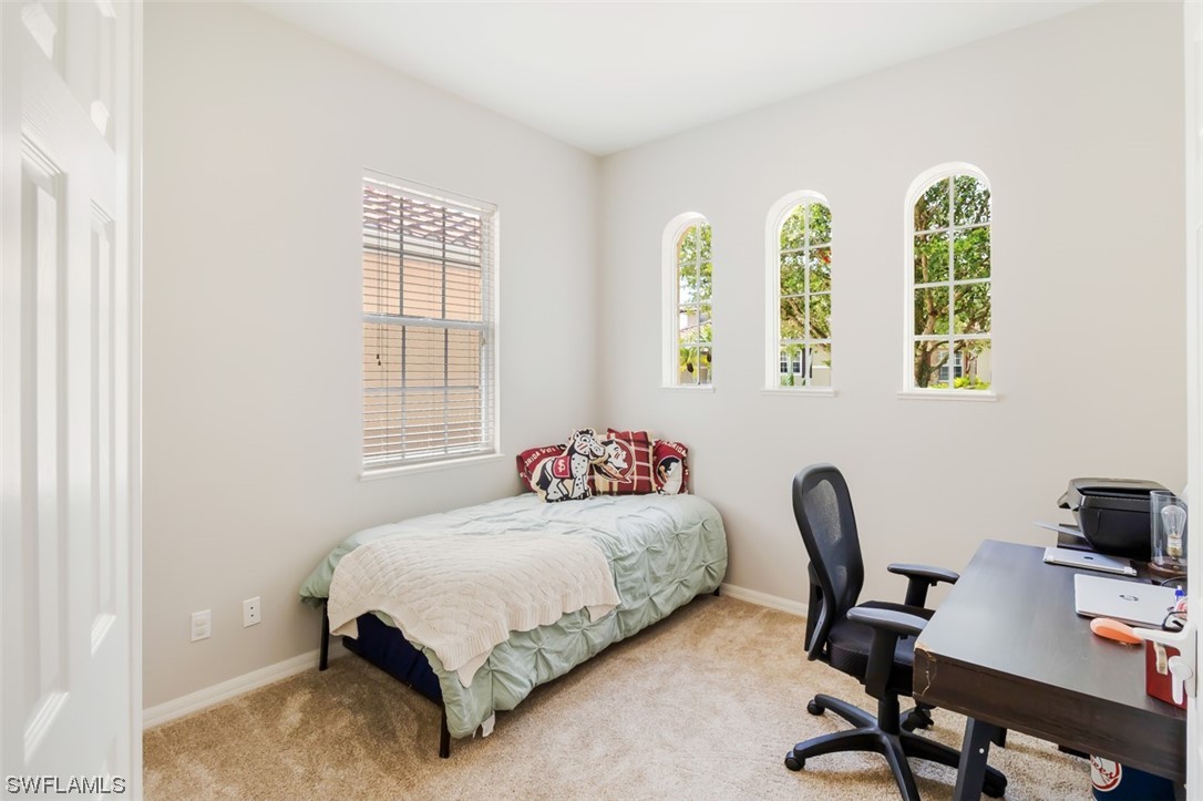 12893 Timber Ridge Drive Fort Myers, FL 33913 - Photo 21 of 30 a bedroom with a bed and a desk