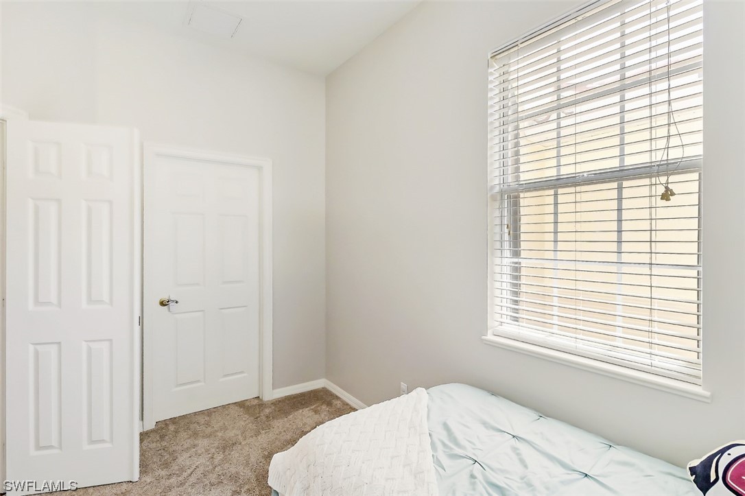12893 Timber Ridge Drive Fort Myers, FL 33913 - Photo 22 of 30 a bedroom with a bed and a window