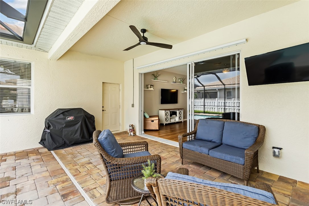12893 Timber Ridge Drive Fort Myers, FL 33913 - Photo 27 of 30 a living room with furniture a flat screen tv and a window