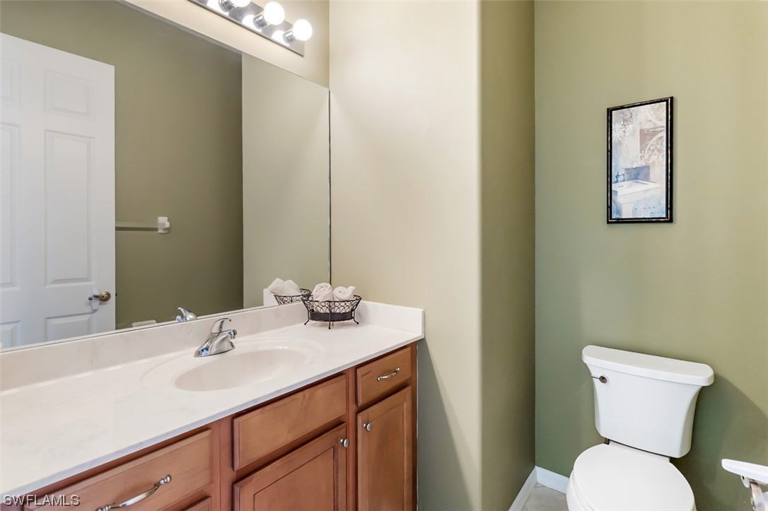 12893 Timber Ridge Drive Fort Myers, FL 33913 - Photo 4 of 30 a bathroom with a toilet sink and mirror