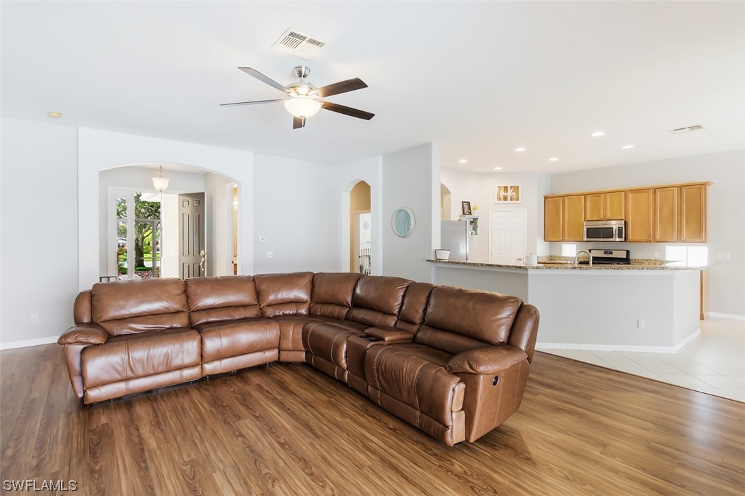 12893 Timber Ridge Drive Fort Myers, FL 33913 - Photo 7 of 30 a living room with furniture and a wooden floor