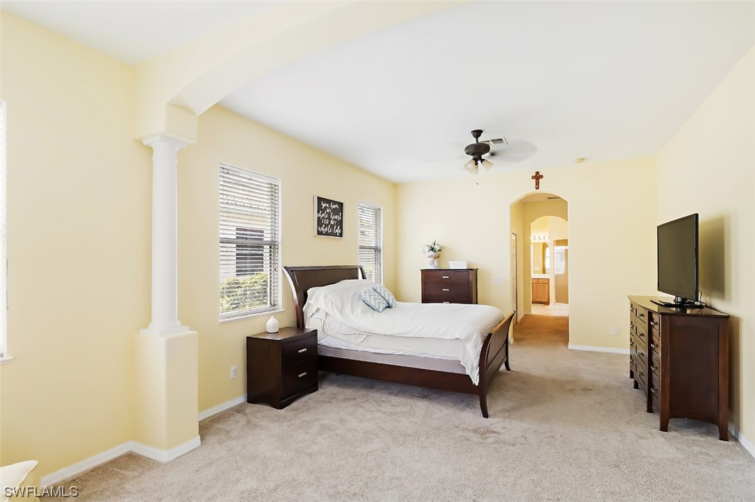 12893 Timber Ridge Drive Fort Myers, FL 33913 - Photo 10 of 30 a bedroom with a bed a flat screen tv and dresser