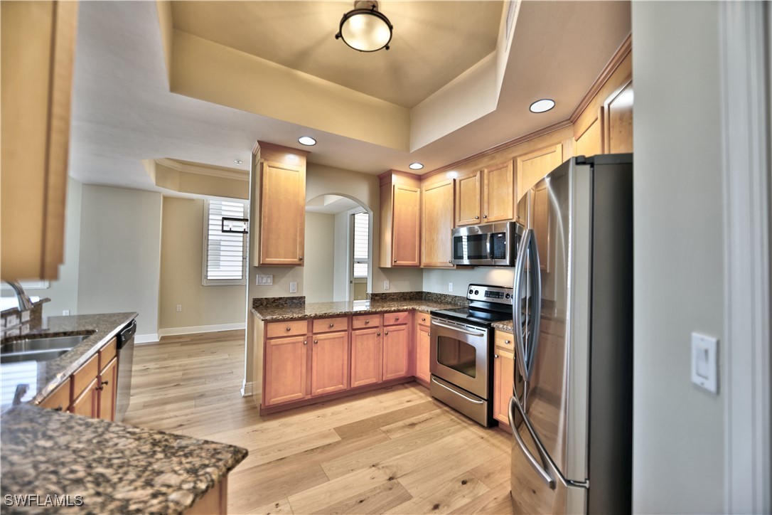 2104 West First Street, Unit 2804 Fort Myers, FL 33901 - Photo 11 of 49 a kitchen with stainless steel appliances granite countertop a refrigerator a stove and a sink
