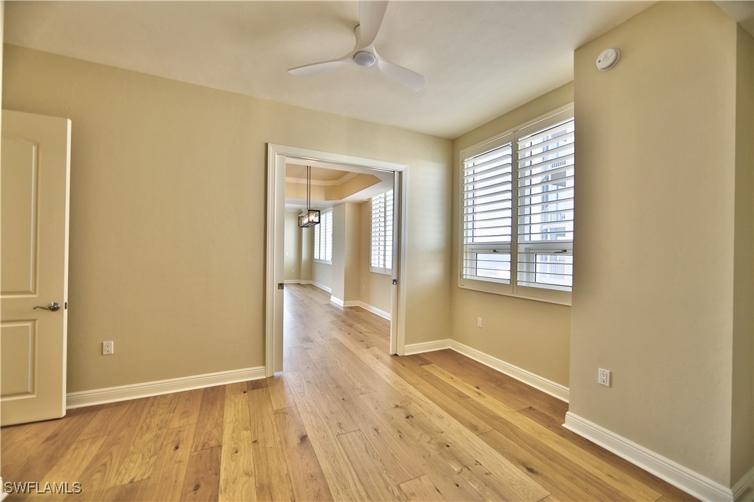 2104 West First Street, Unit 2804 Fort Myers, FL 33901 - Photo 17 of 49 an empty room with wooden floor and windows