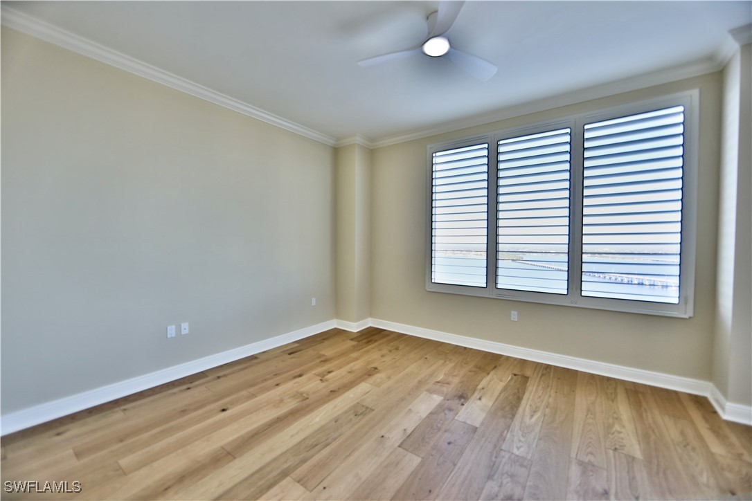 2104 West First Street, Unit 2804 Fort Myers, FL 33901 - Photo 19 of 49 wooden floor in an empty room with a window