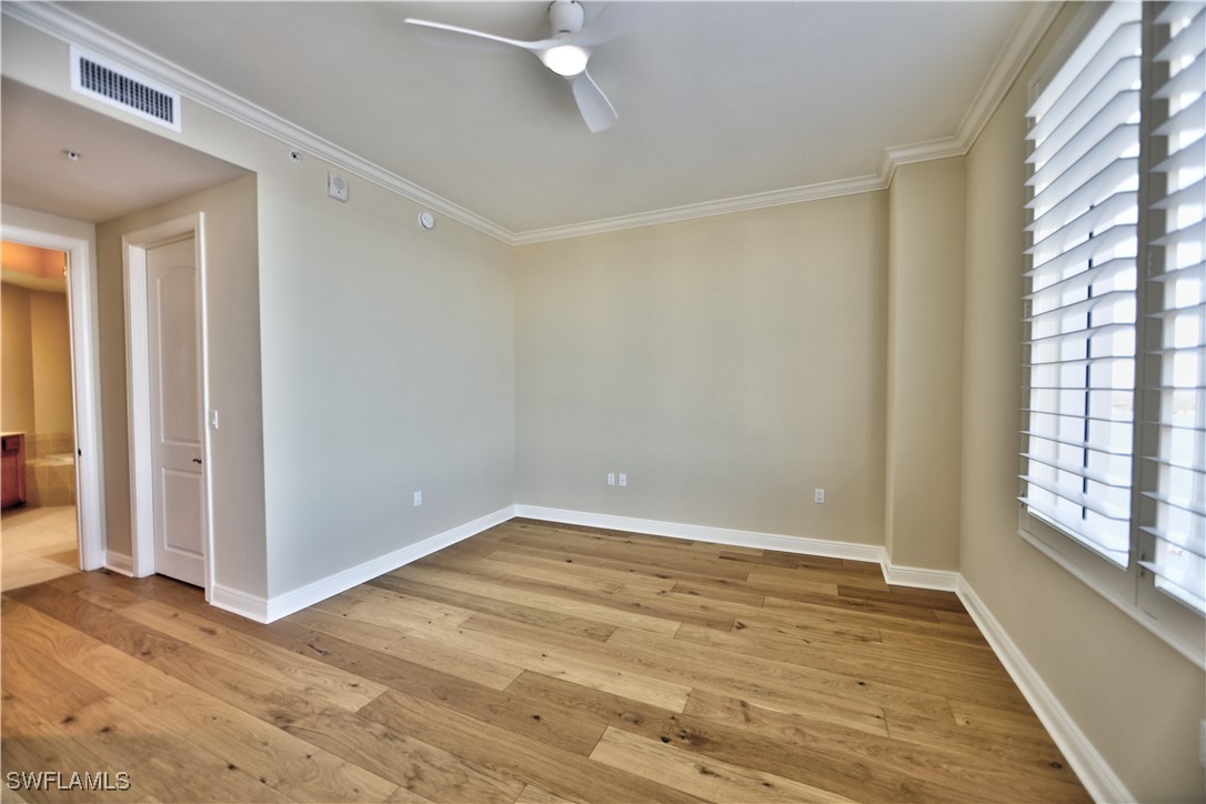 2104 West First Street, Unit 2804 Fort Myers, FL 33901 - Photo 21 of 49 a view of an empty room with wooden floor and a window