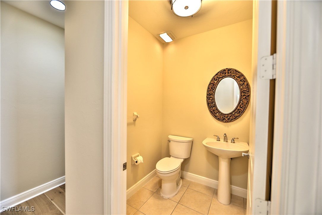 2104 West First Street, Unit 2804 Fort Myers, FL 33901 - Photo 33 of 49 a bathroom with a toilet sink and a mirror