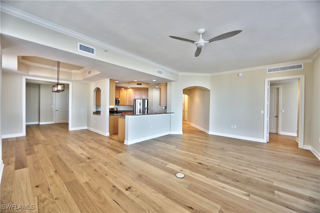 2104 West First Street, Unit 2804 Fort Myers, FL 33901 - Photo 4 of 49 a view of a kitchen with wooden floor and a ceiling fan